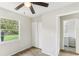 Bedroom featuring wood-look floors, a ceiling fan, a window, and closet at 7711 Amherst St # A & B, Tampa, FL 33625