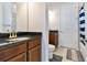 Bathroom with dark brown vanity, granite countertop, and view to bedroom at 8310 Ivy Stark Blvd, Wesley Chapel, FL 33545