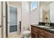 Bathroom with dark brown vanity, granite countertop, and shower at 8310 Ivy Stark Blvd, Wesley Chapel, FL 33545