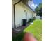 Exterior view of a home featuring a trash can and an AC unit in the backyard at 8630 Winter Haven Dr, Hudson, FL 34667