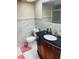 This bathroom features white marble tiling, a white toilet, and a dark vanity at 8630 Winter Haven Dr, Hudson, FL 34667