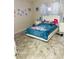 Bedroom with white bed frame and cartoon decals, paired with tile floors at 8630 Winter Haven Dr, Hudson, FL 34667