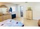 Bright bedroom features tile floors, dresser, and decor, partially visible bed with colorful comforter at 8630 Winter Haven Dr, Hudson, FL 34667