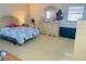 Bright bedroom with tile floors and dresser, featuring a bed with a blue comforter and neutral walls at 8630 Winter Haven Dr, Hudson, FL 34667