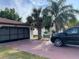 Exterior view of a single-story home, featuring a spacious garage, driveway, and mature landscaping at 8630 Winter Haven Dr, Hudson, FL 34667