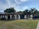 A beautiful single-story home with solar panels, a large yard, and mature trees at 8630 Winter Haven Dr, Hudson, FL 34667