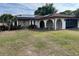 Well-maintained one-story home with solar panels and arched entry into a screened porch at 8630 Winter Haven Dr, Hudson, FL 34667