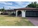Charming single-story home featuring a stone accent wall, arched entry, and a spacious two-car garage at 8630 Winter Haven Dr, Hudson, FL 34667