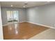 Bright living space featuring hardwood floors, large sliding glass doors, and neutral color palette at 8630 Winter Haven Dr, Hudson, FL 34667
