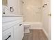 Updated bathroom featuring a shower over tub with marble-style tiled walls, a modern vanity and wood-look flooring at 8659 Fancy Finch Dr # 102, Tampa, FL 33614