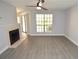 Living room featuring modern flooring, a ceiling fan and a cozy fireplace at 8659 Fancy Finch Dr # 102, Tampa, FL 33614