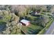This property features a spacious home and a large barn surrounded by lush greenery and mature trees at 8946 Old Pasco Rd, Wesley Chapel, FL 33544