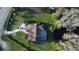 Aerial shot of a home with a screened-in pool and pond at 8946 Old Pasco Rd, Wesley Chapel, FL 33544