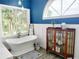 Bathroom with a free standing tub, arched window and traditional decor at 8946 Old Pasco Rd, Wesley Chapel, FL 33544