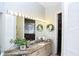 Well-lit bathroom featuring a granite countertop, large mirror, and stylish decorations at 8946 Old Pasco Rd, Wesley Chapel, FL 33544