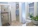 Bathroom featuring a glass door shower, decorative accents, and modern toilet at 8946 Old Pasco Rd, Wesley Chapel, FL 33544