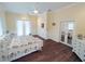 Spacious bedroom with hardwood floors, bright windows, and elegant furnishings at 8946 Old Pasco Rd, Wesley Chapel, FL 33544