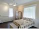 Bright bedroom featuring beautiful wooden floors, ample lighting, and stylish decor at 8946 Old Pasco Rd, Wesley Chapel, FL 33544