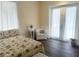 Comfortable bedroom featuring a plush armchair, and access to the backyard at 8946 Old Pasco Rd, Wesley Chapel, FL 33544