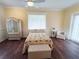 Inviting bedroom with decorative wardrobe, natural light, and comfortable furniture at 8946 Old Pasco Rd, Wesley Chapel, FL 33544