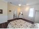 Comfortable bedroom featuring hardwood floors, double doors, and a ceiling fan at 8946 Old Pasco Rd, Wesley Chapel, FL 33544