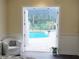 Bedroom view showcasing access to an inviting pool area and outdoor scenery at 8946 Old Pasco Rd, Wesley Chapel, FL 33544