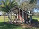 Wide shot of an enclosed chicken coop in the yard with chickens at 8946 Old Pasco Rd, Wesley Chapel, FL 33544