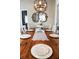 Dining room with a wood table, white chairs, decorative runner, and ornate mirror on the wall at 8946 Old Pasco Rd, Wesley Chapel, FL 33544