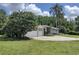 Well-maintained home with a lush lawn and ample driveway space, enhanced by mature trees at 8946 Old Pasco Rd, Wesley Chapel, FL 33544