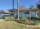 Charming single-story home featuring a well-manicured lawn and garden, with a beautiful rounded window at 8946 Old Pasco Rd, Wesley Chapel, FL 33544