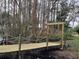 Picturesque view of a wooden foot bridge leading into a tranquil, wooded area, enhancing the property's charm at 8946 Old Pasco Rd, Wesley Chapel, FL 33544