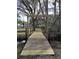 View of a wooden foot bridge over a small creek, creating a serene and inviting outdoor space at 8946 Old Pasco Rd, Wesley Chapel, FL 33544