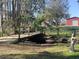 Scenic wooden foot bridge with rope railings, enhancing the natural beauty of the property at 8946 Old Pasco Rd, Wesley Chapel, FL 33544