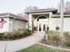 Inviting home entrance with a grand archway, well-maintained landscaping, and a welcoming pathway at 8946 Old Pasco Rd, Wesley Chapel, FL 33544
