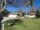 Charming home with a well-manicured lawn, mature trees, and a three-car garage, offering curb appeal at 8946 Old Pasco Rd, Wesley Chapel, FL 33544