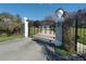 Elegant wrought iron gate with decorative accents and a secure entry system at 8946 Old Pasco Rd, Wesley Chapel, FL 33544