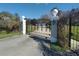 Elegant gated entrance with decorative columns and lush greenery, ensuring privacy and security at 8946 Old Pasco Rd, Wesley Chapel, FL 33544