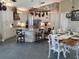 Open concept kitchen with white cabinets, brick accent wall, granite counters, and an island with seating at 8946 Old Pasco Rd, Wesley Chapel, FL 33544