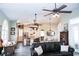 Bright, open-concept living space with high ceilings, ceiling fans, and a view into the kitchen at 8946 Old Pasco Rd, Wesley Chapel, FL 33544