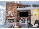 Charming living room with a wood-paneled wall, fireplace, and built-in shelves at 8946 Old Pasco Rd, Wesley Chapel, FL 33544