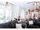 Spacious living room with large windows, comfortable seating, and a view of the adjoining kitchen at 8946 Old Pasco Rd, Wesley Chapel, FL 33544