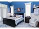 Brightly lit main bedroom featuring traditional wainscoting, matching night stands and furniture at 8946 Old Pasco Rd, Wesley Chapel, FL 33544