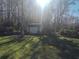 Scenic exterior view of a small, green outbuilding with a charming design at 8946 Old Pasco Rd, Wesley Chapel, FL 33544