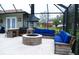 Inviting outdoor patio with a stone fireplace, custom seating, and bar area for entertaining at 8946 Old Pasco Rd, Wesley Chapel, FL 33544