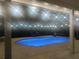 Stunning pool illuminated at night with overhead lights, creating a tranquil oasis at 8946 Old Pasco Rd, Wesley Chapel, FL 33544