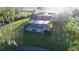 Aerial view of a screened-in pool attached to the house, with a view of pond at 8946 Old Pasco Rd, Wesley Chapel, FL 33544