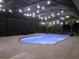Enclosed in-ground pool with lights, mature palm trees, and deck chairs for relaxing poolside at 8946 Old Pasco Rd, Wesley Chapel, FL 33544