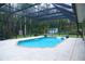 Large screened-in pool with a travertine deck, perfect for relaxing and entertaining in a private outdoor space at 8946 Old Pasco Rd, Wesley Chapel, FL 33544