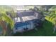 Screened-in pool with an outdoor lounge area, perfect for relaxation and entertaining at 8946 Old Pasco Rd, Wesley Chapel, FL 33544