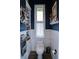 Traditional powder room with decorations, wainscoting and lots of storage at 8946 Old Pasco Rd, Wesley Chapel, FL 33544